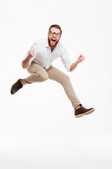 Cheerful young bearded man jumping