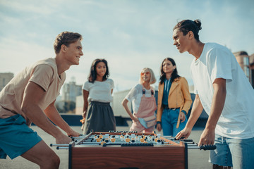 friends playing table football