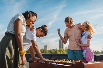 friends playing table football