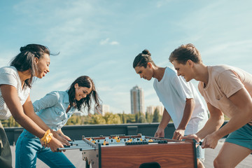 friends playing table football