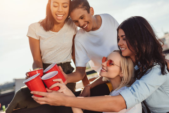 friends clinking with plastic cups