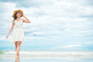 Asian woman feeling relax on beach with blue sky and sea in holiday vacation summer