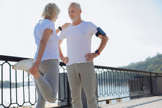 Fit woman leaning on husband while stretching