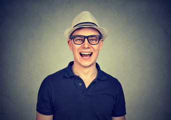 young laughing man with hat and glasses