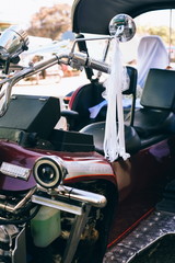 Beautiful wedding concept big trike, motorbike decorated with balloons and ribbon