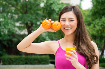 Asian healthy woman eat orange juice for health with smile