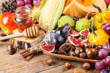 Fall autumn harvest background with pumpkin apple chestnut corn