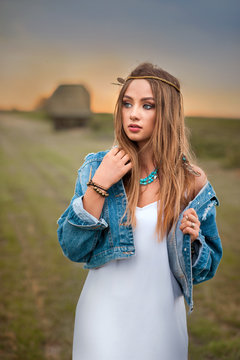 beautiful boho hippie girl with jeans jacket and white dress