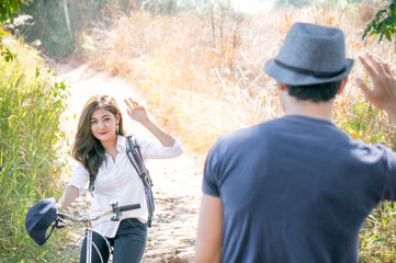 Asian woman greet boyfriend in forest