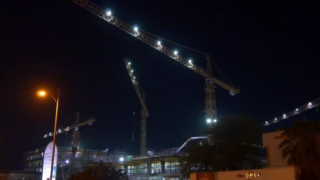 night illuminated dubai jumeirah working cranes hotel construction up view 4k uae
