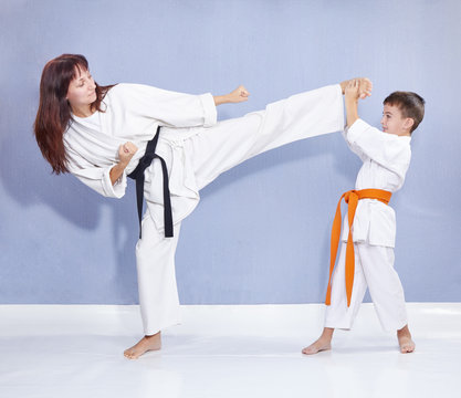 Mother and son are training kick leg