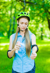 Woman spraying insect repellents on skin