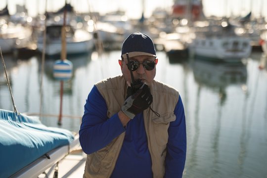 Yachtsman using walkie talkie