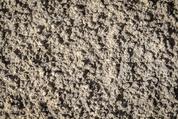 Decorative concrete surface of a wall close-up as background.