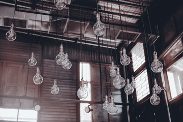 Fototapeta na wymiar Light bulb / View of light bulb hang on the ceiling. Under view.