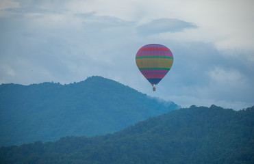 Balloons, sky, clouds and mountains in the morning, isubject is blurred.