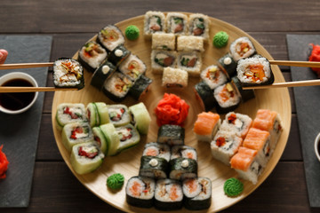 Eating set of sushi maki and rolls in japanese resaturant