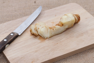 Galangal on wooden cutting board