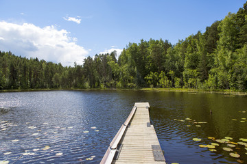 Traditional landscape from Finland during the summer day. Wooden pier by the lake.