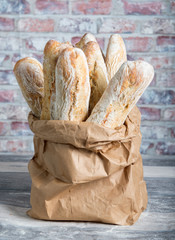 Fresh baked rustic bread loaves in paper bags