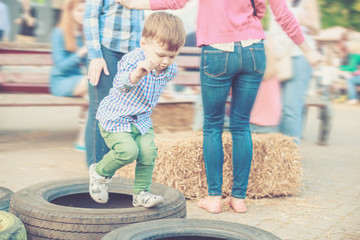 Boy Playing Jumping Tires on Street Festival © ansyvan