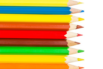 Fototapeta premium Colored pencils in a row on the left
