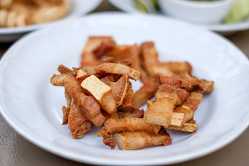 Fried pork belly / fried streaky pork, snack made of deep fried pork meat with fatty skin. Famous food in Chiang Mai in Northern Thailand.