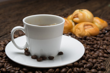 Coffee cup with bread sausage and coffee beans