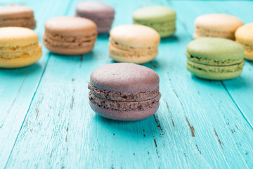 studio shoot of colorful macaroons on a blue wood background