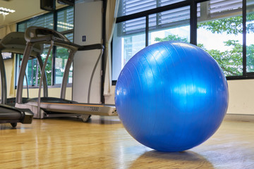 exercise ball for fitness on wooden floor.