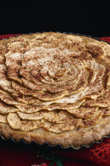 Apple tart lying on traditional Ukrainian headscarf