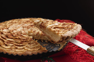 Apple tart lying on traditional Ukrainian headscarf