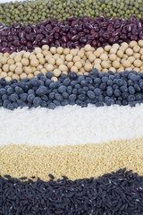 Different colorful beans and rice close up. Soybeans, black beans, mung beans,red beans, rice, black rice.
