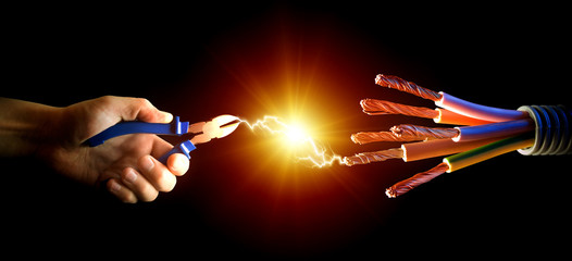 Electric cord and electrician hand as symbol of power - obrazy, fototapety, plakaty
