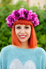 Attractive red haired girl with wreath of flowers