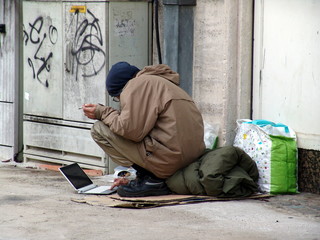 homeless man with laptop