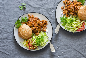 Minced pork burger with salad on grey background, top view. Flat lay