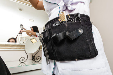 Professional hairdresser tools in belt