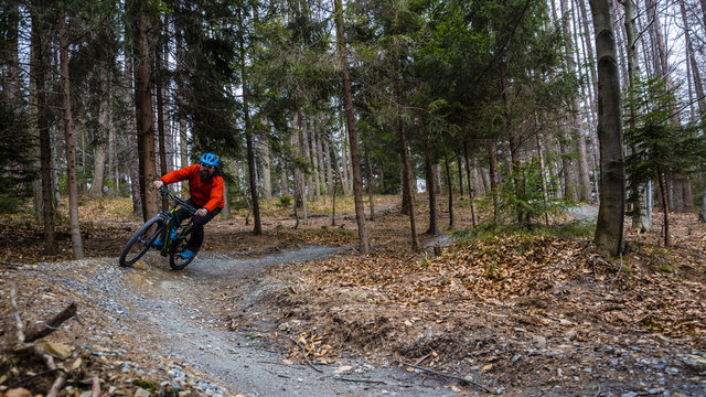 Cycling in autumn mountains forest landscape. Man cycling MTB enduro flow trail track. Outdoor sport activity.