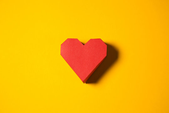 Red Paper Heart On A Yellow Background