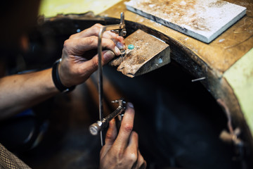 Jeweler using saw