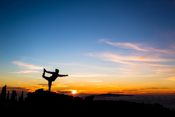 Fototapeta na wymiar Woman meditating in yoga dancer pose, inspiring landscape