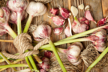 Fresh vegetables, garlic on a rustic wooden background. View from above.