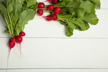 Radishes on a white wooden background