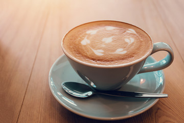 Cup of coffe on workplace desk, coffee shop.