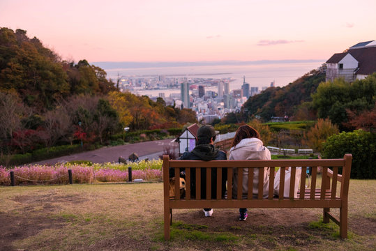 young couple see Kobe skyline at twilight