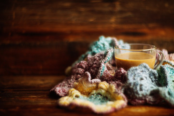 cozy soft gray blanket with a big red cup on the background of a window decorated with frost / warming moments winter holidays