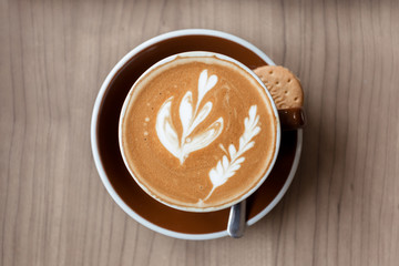 Cup of coffee with laptop computer on the table.