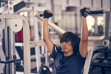 Asian man exercising in the gym, fitness, health, body good.