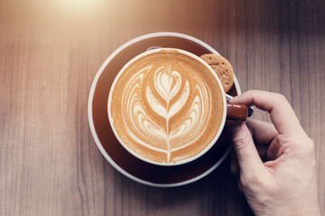 Hand holding coffee cup.